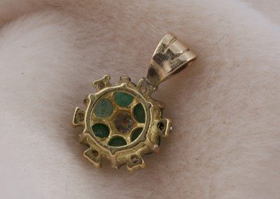 Lot 141 - An 18ct gold emerald and diamond cluster pendant
