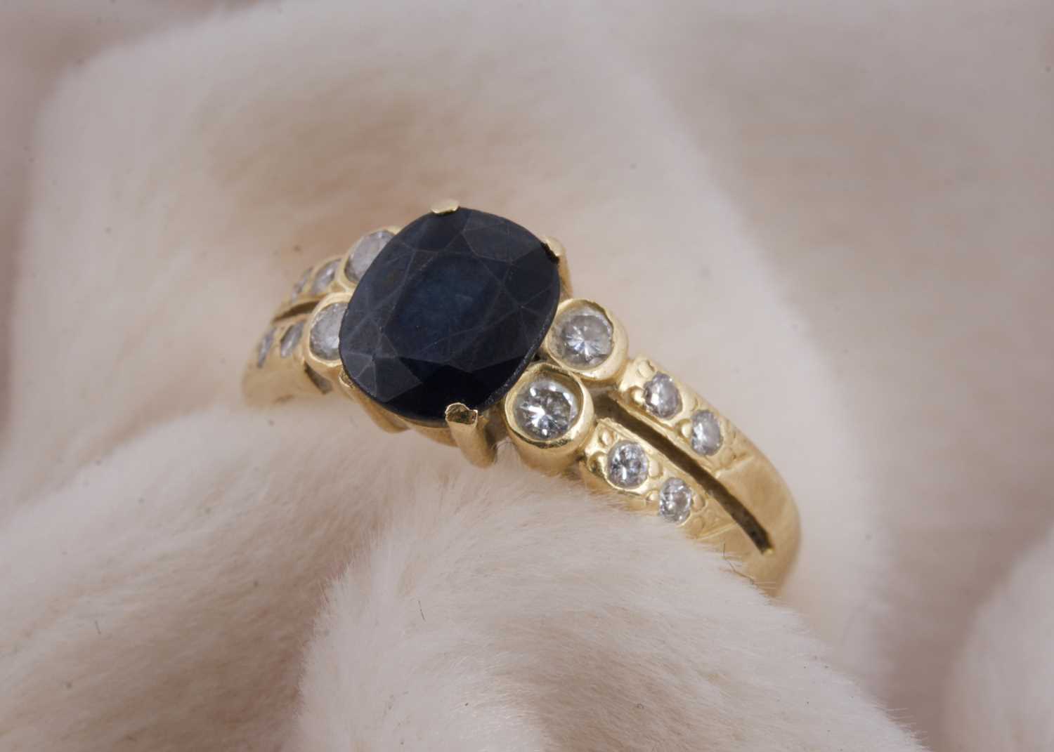 Lot 143 - An 18ct gold sapphire and diamond dress ring