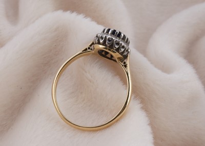 Lot 144 - An 18ct gold and platinum sapphire and diamond cluster ring