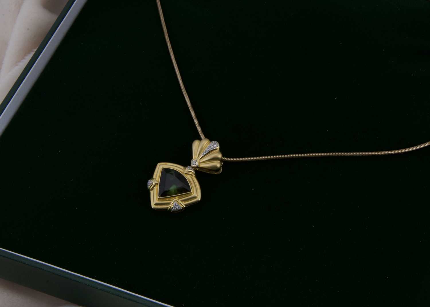 Lot 160 - An 18ct gold diamond and tourmaline pendant and chain