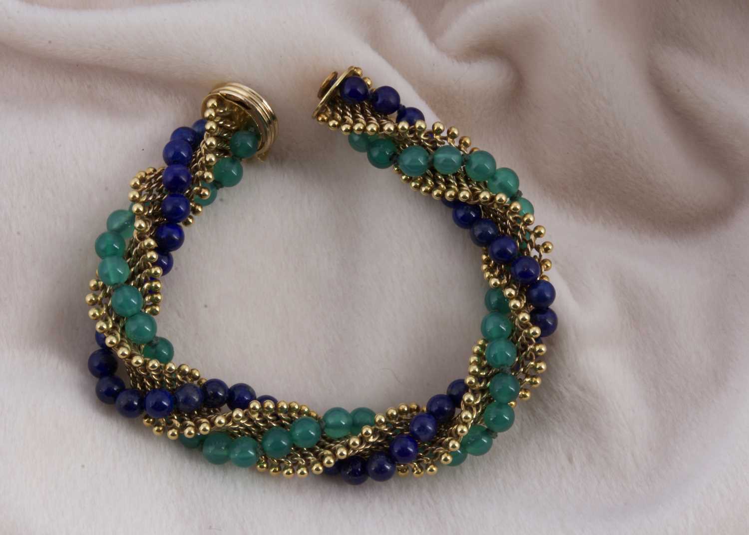 Lot 161 - An 18ct gold lapis lazuli and green chalcedony twist bracelet