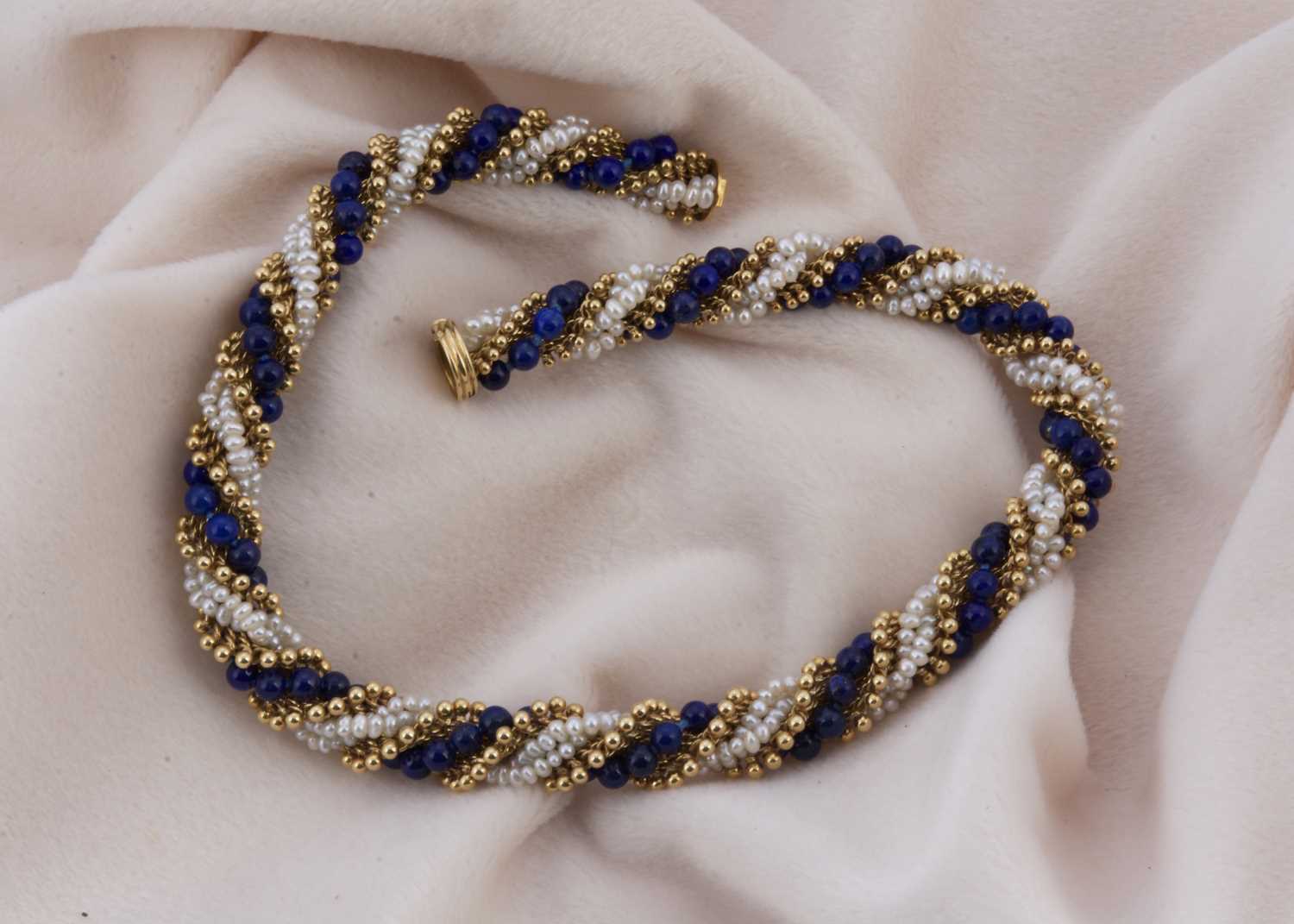 Lot 162 - A Van Cleef & Arpels 18ct gold seed pearl and lapis lazuli twist necklace