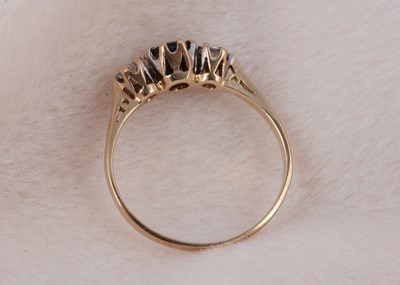Lot 164 - A three stone 9ct gold sapphire and diamond ring