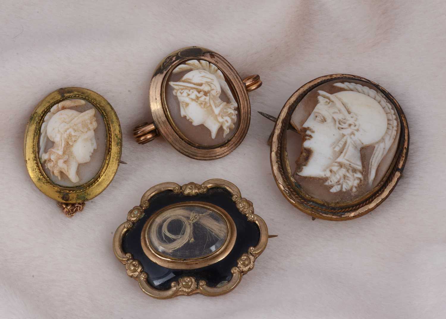 Lot 173 - A 19th Century plaited hair black enamel and gilt metal mourning brooch