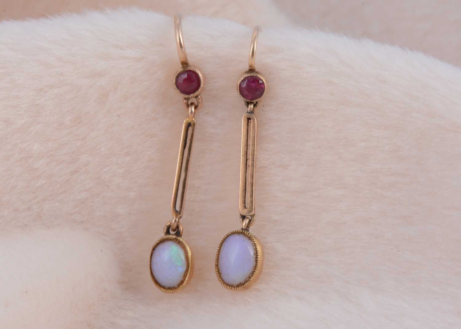 Lot 188 - A pair of moonstone and ruby drop earrings
