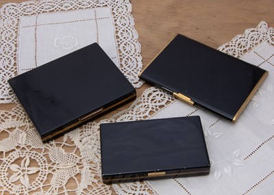 Lot 294 - Three rectangular Art Deco black enamel and gilt metal rectangular carryalls
