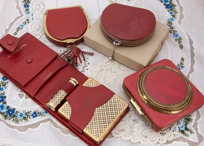 Lot 297 - Four red leather compacts