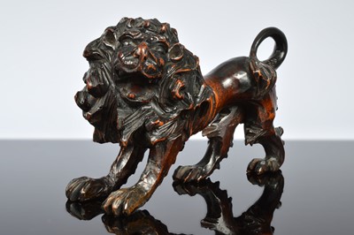 Lot 362 - A 19th century carved wooden figure of a lion