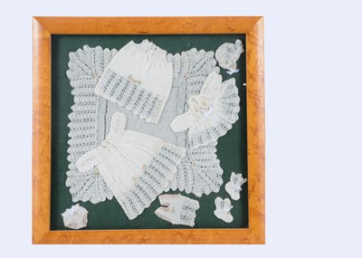 Lot 261 - A framed set of finely knitted small doll’s clothes