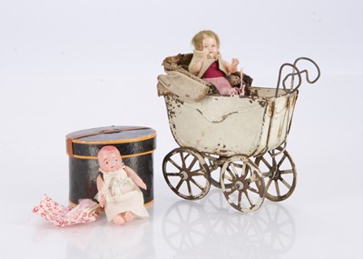 Lot 272 - A small circular cardboard hat box containing a celluloid baby doll