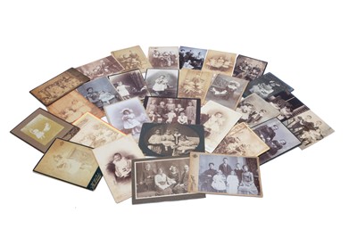 Lot 476 - Twenty-seven 19th century photographic Cabinet Cards featuring children with dolls and toys