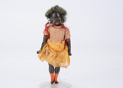 Lot 488 - A small late 19th century German composition black girl doll