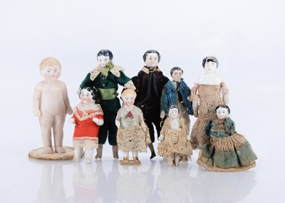 Lot 635 - A collection of four china shoulder-head dolls’ house dolls and five Frozen Charlottes