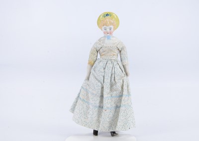 Lot 648 - An early German white china shoulder-head doll with yellow moulded bonnet