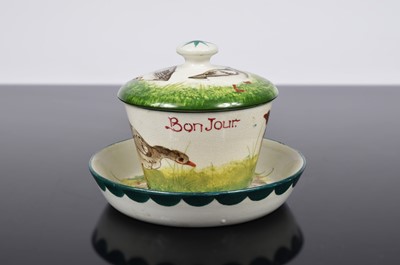 Lot 143 - A Wemyss Ware pottery covered chocolate cup and saucer