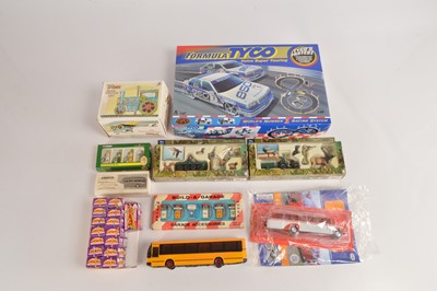 Lot 470 - Various Model vehicles and related items including Tyco Slot Car Set Buses Mokes Awakening boxed sets New Ray Wild Hunting  Kovap Tin Roller and Petrol Pumps sets (25)
