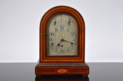 Lot 28 - A late Victorian or Edwardian mahogany and inlaid mantle clock
