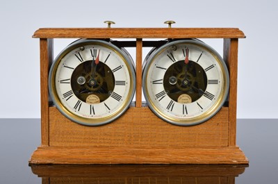 Lot 65 - An Art Deco period "The Reliable Chess Timer" twin clock in oak case