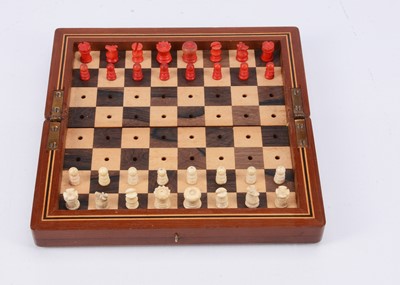 Lot 141 - A small turned wooden chess set