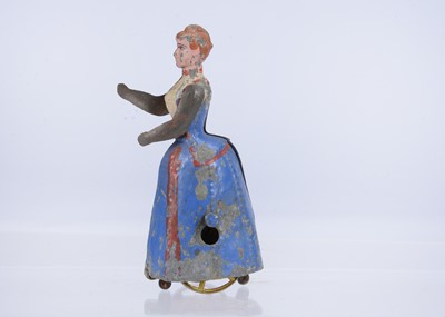 Lot 400 - A late 19th century German fly-wheel driven painted tinplate lady