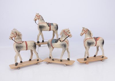 Lot 421 - Four early 20th century German wooden horses on wheels