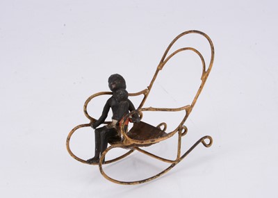 Lot 452 - A German lead black boy and his younger brother on rocking chair