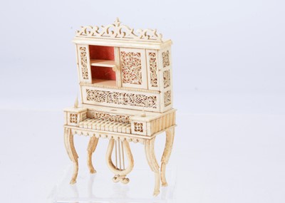 Lot 473 - A 19th century bone doll’s house pianola cabinet