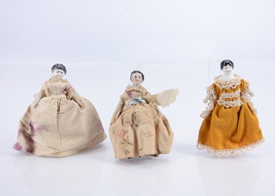 Lot 519 - Three 19th century china shoulder-head dolls’ house dolls
