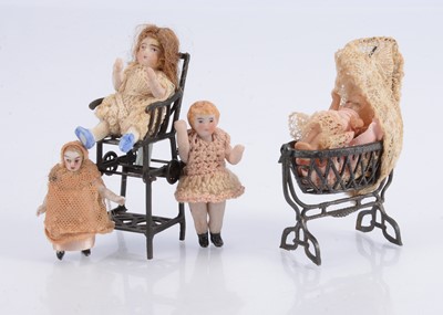 Lot 522 - French penny toy highchair and cradle with dolls