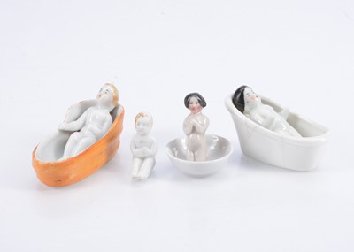 Lot 526 - Three 19th century china Frozen Charlottes in baths