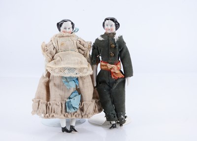 Lot 531 - Two 19th century china larger size shoulder-head dolls’ house dolls