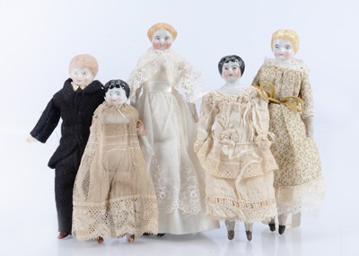 Lot 570 - Five late 19th century bisque and china shoulder-head dolls’ house dolls