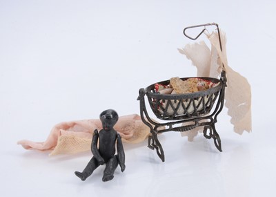 Lot 576 - A French penny toy dolls’ house cradle with two all-bisque dolls
