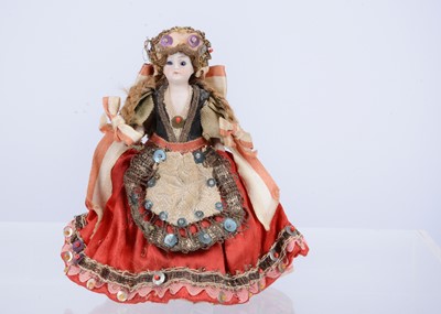 Lot 581 - A small German all-bisque dolls’ house doll in original costume