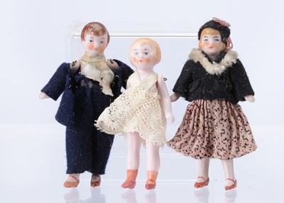 Lot 648 - A 1920s German pair of pink tinted all-bisque dolls’ house dolls