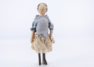 Lot 680 - A mid 19th century Grodnertal carved wooden shoulder-head doll