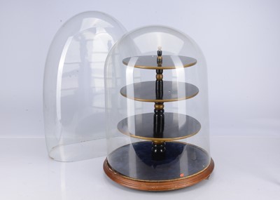 Lot 700 - A large glass dome with central black painted wooden shelf
