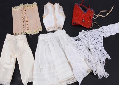Lot 770 - A doll’s pink silk boned corset