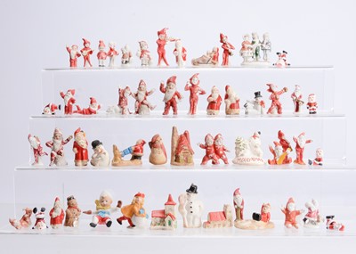 Lot 860 - A bisque and plaster Christmas cake decorations and other ornaments