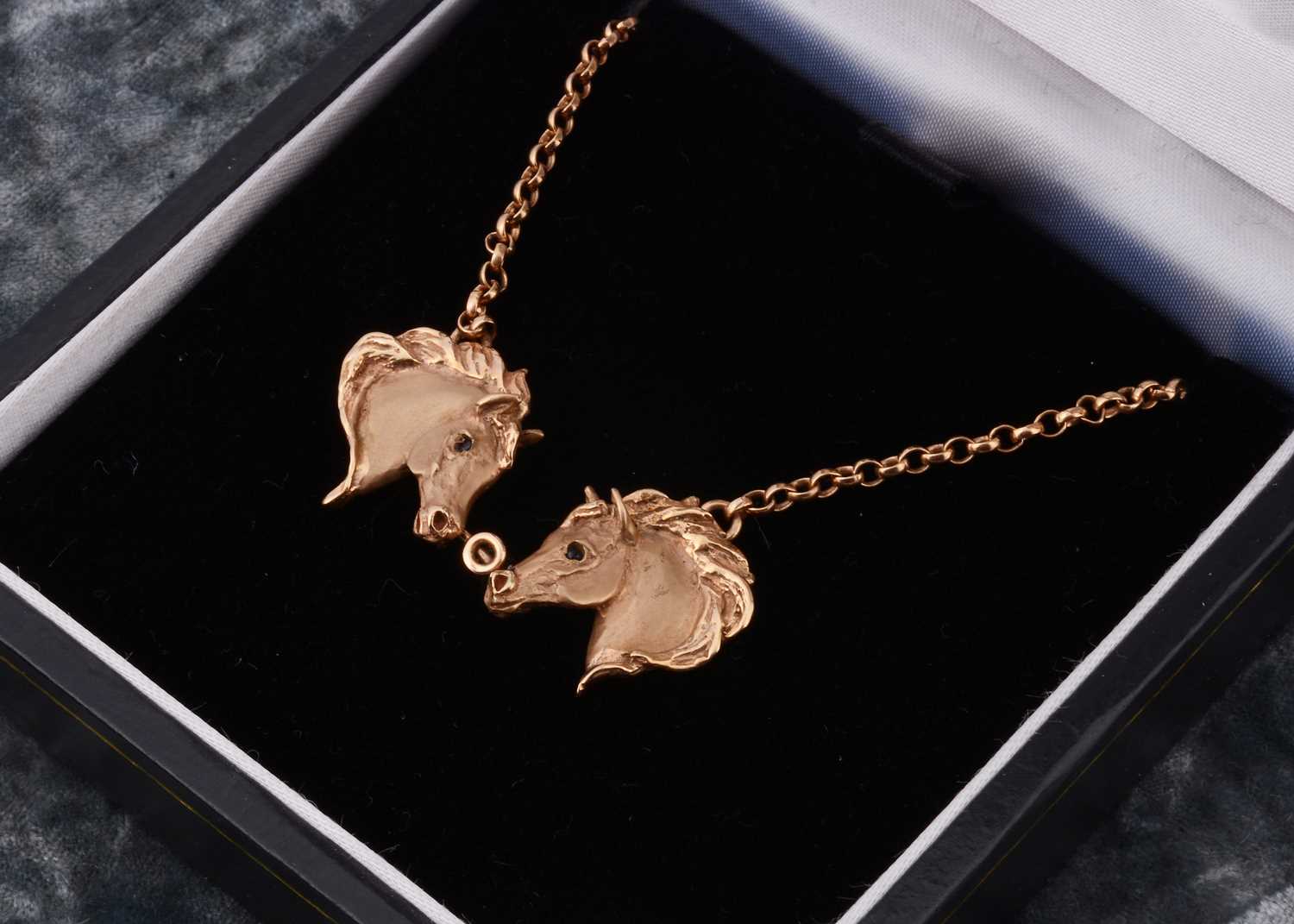 Lot 3 - A 9ct gold double horse head necklace