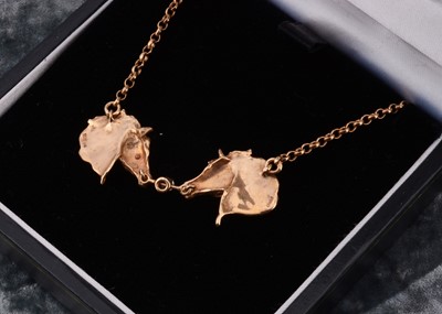 Lot 3 - A 9ct gold double horse head necklace