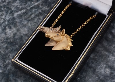 Lot 5 - A 9ct gold double horse head pendant and chain