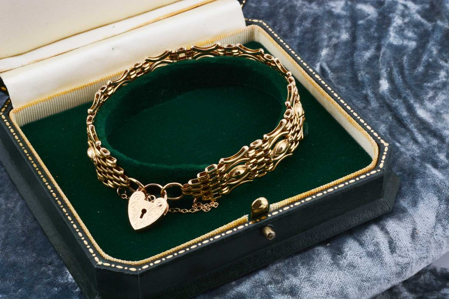 Lot 7 - A 9ct gold celebration gate bracelet