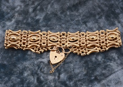 Lot 7 - A 9ct gold celebration gate bracelet