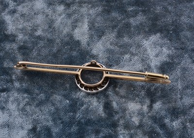Lot 9 - An Edwardian diamond circular winning post bar brooch