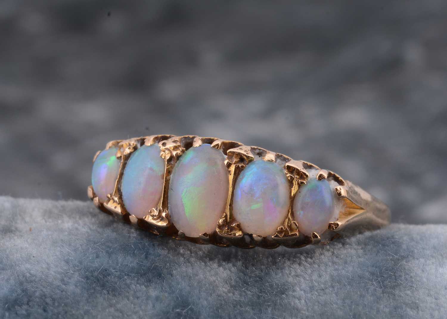 Lot 29 - An 18ct gold five stone opal dress ring