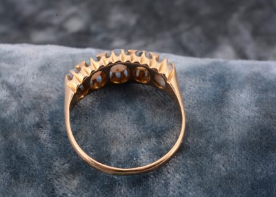 Lot 29 - An 18ct gold five stone opal dress ring