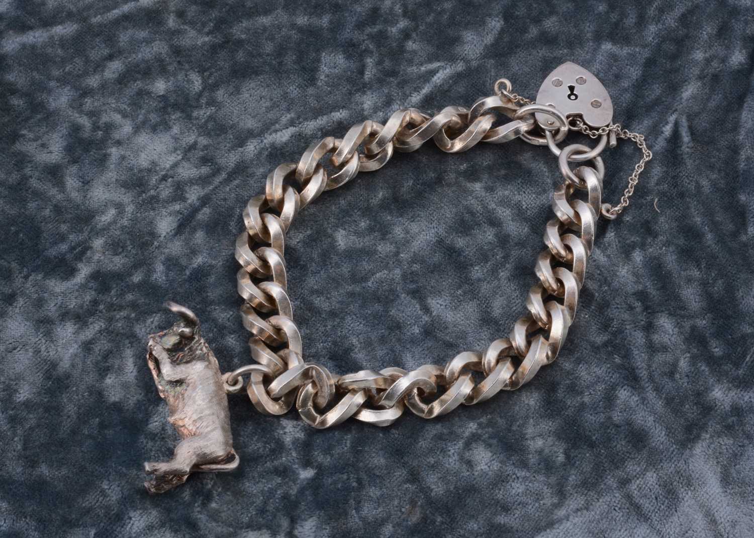 Lot 45 - A silver curb link bracelet with padlock clasp