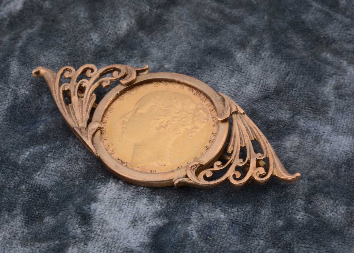 Lot 48 - A Victorian full sovereign 9ct gold mounted brooch
