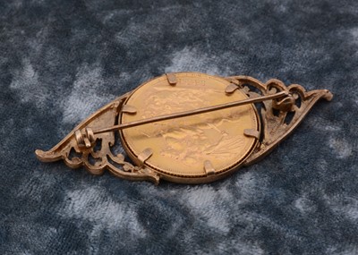 Lot 48 - A Victorian full sovereign 9ct gold mounted brooch